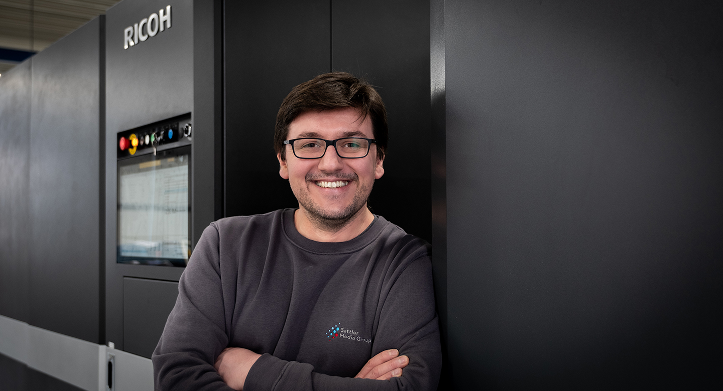 A person with glasses smiling