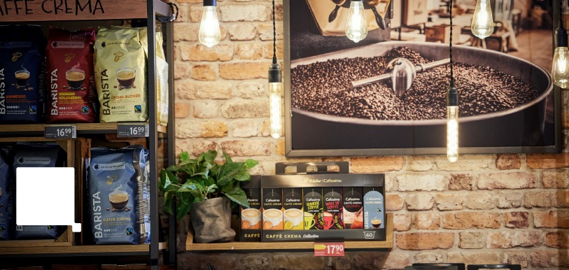 A coffee shop with a picture of coffee beans and a plant